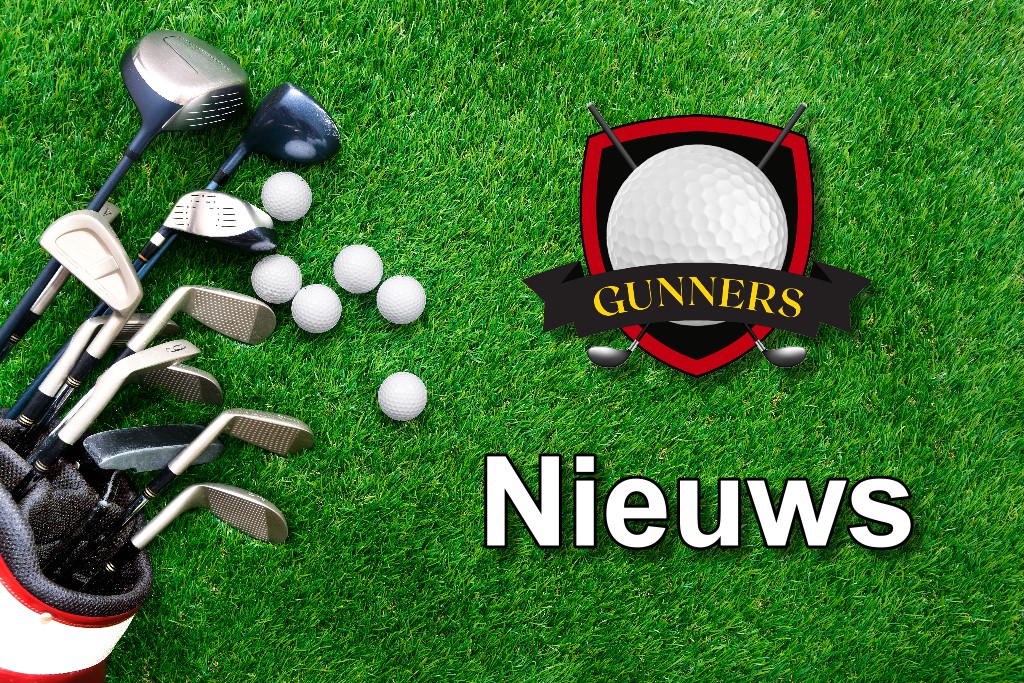 Golf ball and golf club in bag on green grass